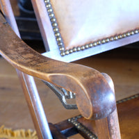 Serpentine arm of a Victorian brass studded leather folding campaign chair reclining armchair circa 1875