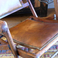 Close up of the studded leather seat - Victorian brass studded leather folding campaign chair reclining armchair circa 1875