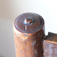 Detail of turned button finial on rear upright of antique Lancashire oak spindle back armchair