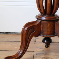 carved cabriole legs on a Late Victorian mahogany oval tilt-top tripod table with open reed column detail