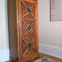side view on a Vintage Teak Linen Cupboard with Lattice Door & Green Stained Glass