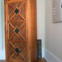 side view on a Vintage Teak Linen Cupboard with Lattice Door & Green Stained Glass