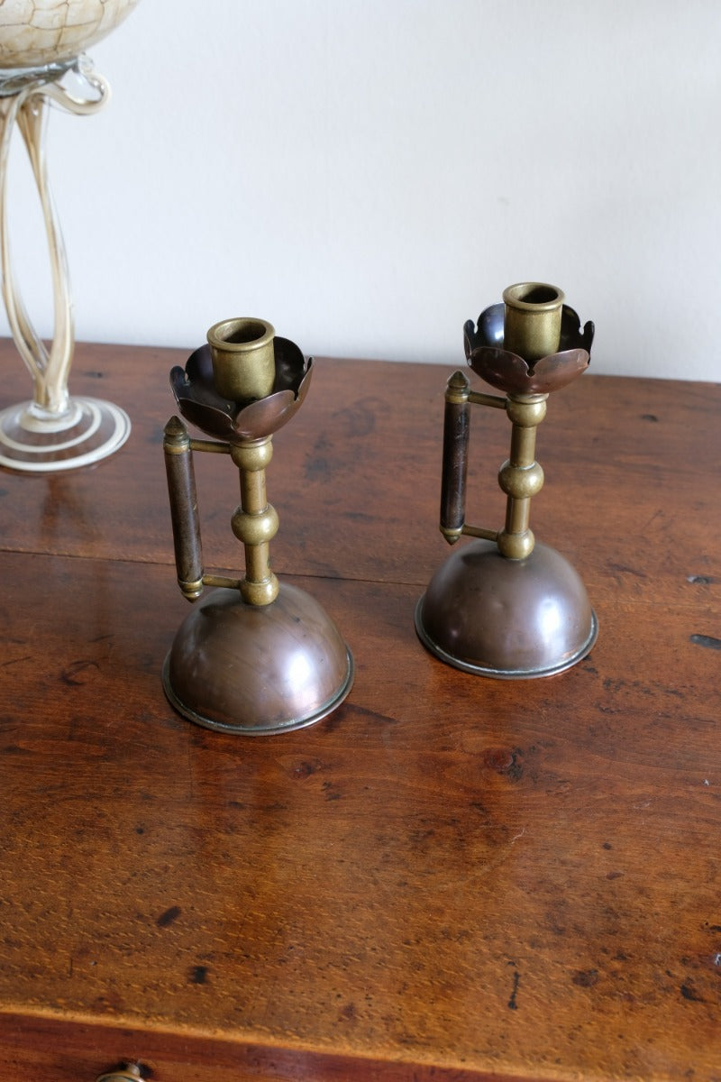 Arts & Crafts copper and brass candlestick pair with patina
