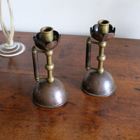 Arts & Crafts copper and brass candlestick pair with patina