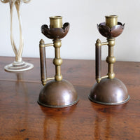 Arts & Crafts copper and brass candlestick pair with patina