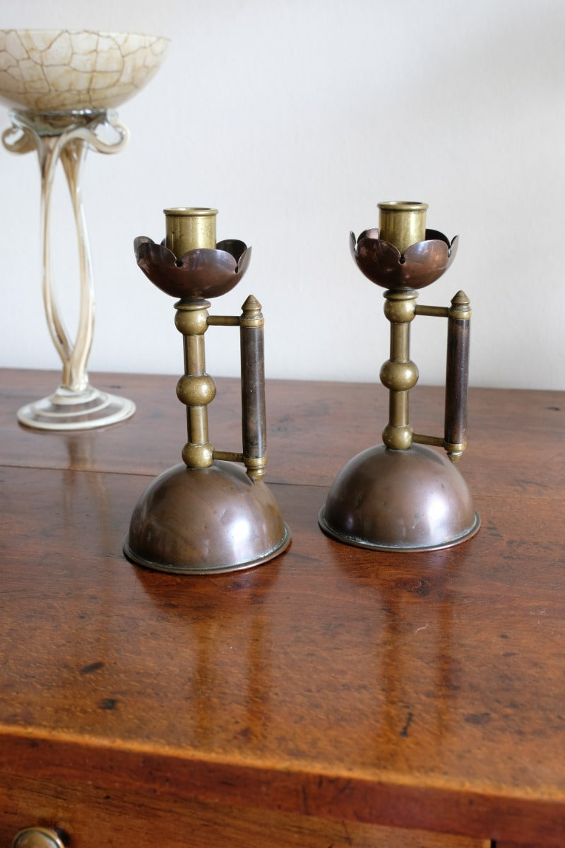 Arts & Crafts copper and brass candlestick pair with patina