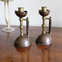 Arts & Crafts copper and brass candlestick pair with patina