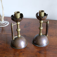 Arts & Crafts copper and brass candlestick pair with patina