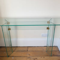 Top view - Modern glass hall table with sculptural metal V-shaped base in Leon Rosen style
