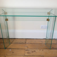 Top view - Modern glass hall table with sculptural metal V-shaped base in Leon Rosen style