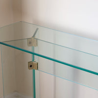 Modern glass hall table with sculptural metal V-shaped base in Leon Rosen style