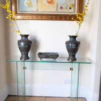 Modern glass hall table with sculptural metal V-shaped base in Leon Rosen style