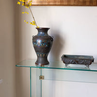 Modern glass hall table with sculptural metal V-shaped base in Leon Rosen style