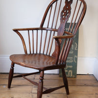 Antique English Windsor armchair in elm with uneven seat and ash stick back