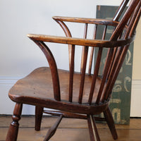 Swept back arms - Antique English Windsor armchair in elm with uneven seat and ash stick back