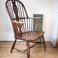 Antique English Windsor armchair in elm with uneven seat and ash stick back