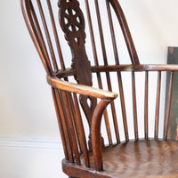 Antique English Windsor armchair in elm with uneven seat and ash stick back