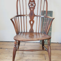Antique English Windsor armchair in elm with uneven seat and ash stick back