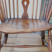 Close up of the gnarly seat - Antique English Windsor armchair in elm with uneven seat and ash stick back
