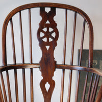 Antique English Windsor armchair in elm with uneven seat and ash stick back