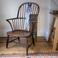 Antique English Windsor armchair in elm with uneven seat and ash stick back