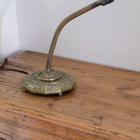 Arts & Crafts brass table lamp with hendecagon base and flexible stem, circa 1900–1920