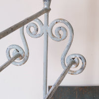 Early 20th century wrought iron freestanding towel rail with scroll ends and aged painted finish