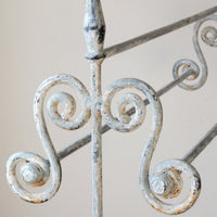 Early 20th century wrought iron freestanding towel rail with scroll ends and aged painted finish