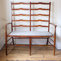 19th century English beech ladder-back bench with linen upholstered horsehair seat and waved slats
