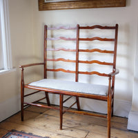 19th century English beech ladder-back bench with linen upholstered horsehair seat and waved slats
