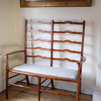 19th century English beech ladder-back bench with linen upholstered horsehair seat and waved slats
