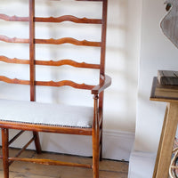 19th century English beech ladder-back bench with linen upholstered horsehair seat and waved slats