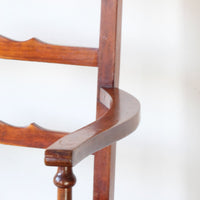 Close up of the serpentine arm - 19th century English beech ladder-back bench with linen upholstered horsehair seat and waved slats