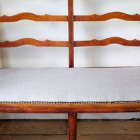 19th century English beech ladder-back bench with linen upholstered horsehair seat and waved slats