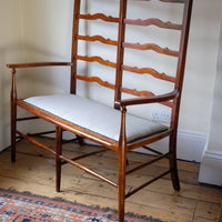 side shot - 19th century English beech ladder-back bench with linen upholstered horsehair seat and waved slats