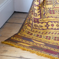 Fringes on the Antique Anatolian kilim rug with saffron ground and geometric motifs