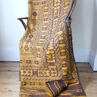 folded ober a chair and turned corner to see the back - Antique Anatolian kilim rug with saffron ground and geometric motifs