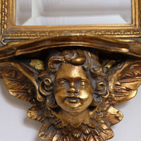 Close up of the Cherub face - Late Victorian gilt wall mirror with original bevelled mirror plate and cherub shelf detail