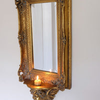 Late Victorian gilt wall mirror with original bevelled mirror plate and cherub shelf detail
