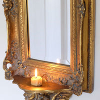 Late Victorian gilt wall mirror with original bevelled mirror plate and cherub shelf detail