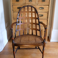 Front view of a Rare Edwardian bentwood lattice back armchair attributed to Jas Shoolbred with pierced Arts & Crafts design