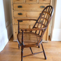 Side view on a Rare Edwardian bentwood lattice back armchair attributed to Jas Shoolbred with pierced Arts & Crafts design