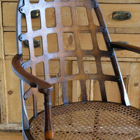 View of the curved notched arms on a Rare Edwardian bentwood lattice back armchair attributed to Jas Shoolbred with pierced Arts & Crafts design
