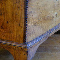 close up of the chip carved corner on an Early 19th Century English Elm Six Plank Coffer Chest With Internal Till