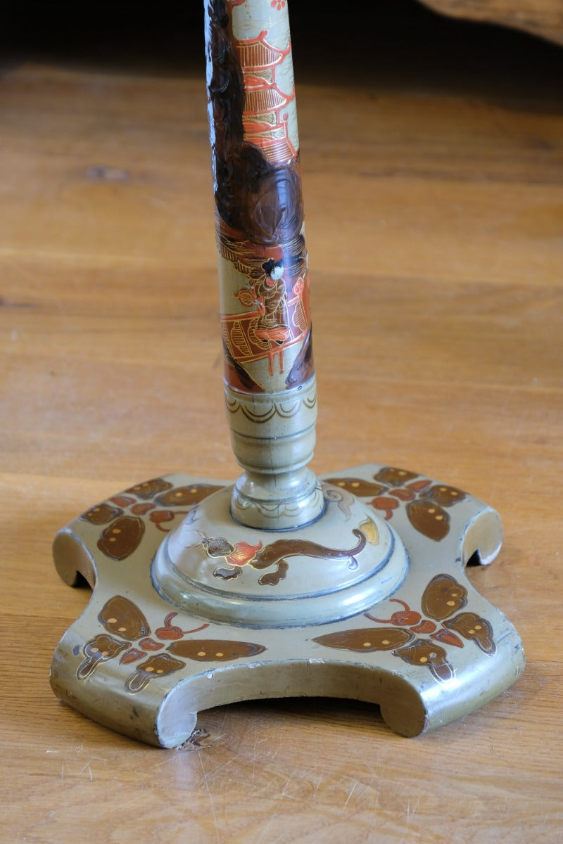 Close‑up gold butterfly feet detail on Chinoiserie pedestal table