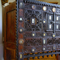 Close up on the relief and carved pierced fretwork decoration - Antique Kutch Damchiya dowry chest with mirror inlay and carved hardwood fretwork, Gujarat c.1900–1930