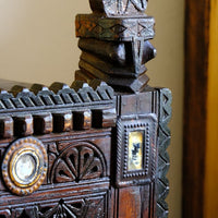 Architectural cresting with carved corner finials on an Antique Kutch Damchiya dowry chest with mirror inlay and carved hardwood fretwork, Gujarat c.1900–1930