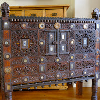 Close up of an Antique Kutch Damchiya dowry chest with mirror inlay and carved hardwood fretwork, Gujarat c.1900–1930