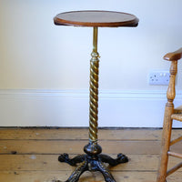 Close up - Antique Victorian brass telescopic wine table with mahogany top and lion’s paw feet