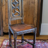 English Arts and Crafts elm hall chair with carved pierced back and hide seat